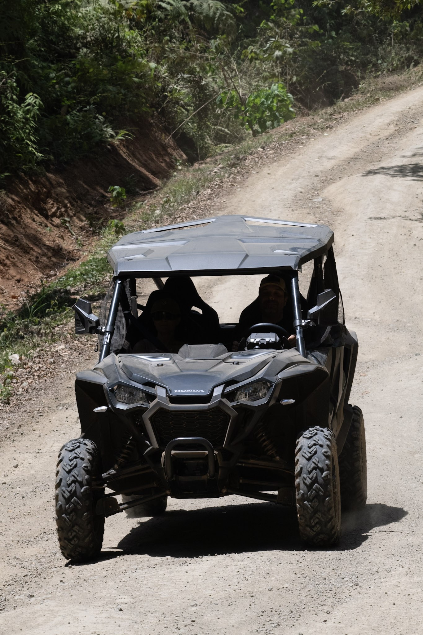 Couple smiling on a Honda TALON 1000X4 off-road tour in Jaco Costa Rica