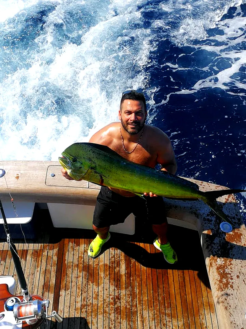 Angler holding a massive Dorado Mahi-Mahi caught out of Marina Los Sueños