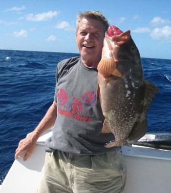 Man holding a hooked fish