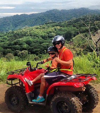 Dad and his child on ATV