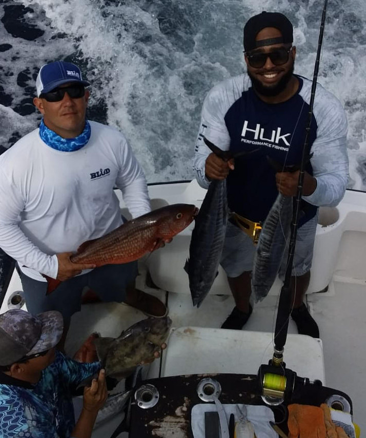 men with fish on charter boat