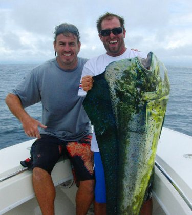 Two men holding a large yellowfin tuna